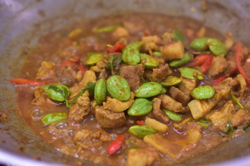 Spicy stir fried pork with Cluster Bean (Bitter Bean or stink beans) popular southern Thai food, Spicy stir fried chicken with Cluster Bean (Bitter Bean or stink beans).Thai southern food
