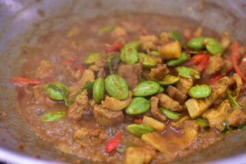 Spicy stir fried pork with Cluster Bean (Bitter Bean or stink beans) popular southern Thai food, Spicy stir fried chicken with Cluster Bean (Bitter Bean or stink beans).Thai southern food