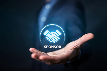 Man holding a glowing handshake icon and the word sponsor