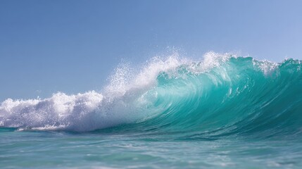 Fototapeta premium Ocean wave rising high before breaking, caught in motion under a bright blue sky