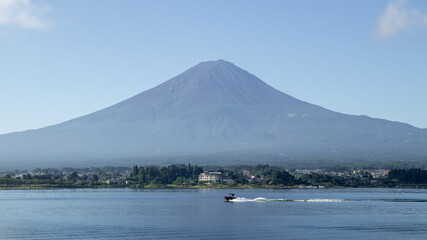 Mount fuji san at Lake kawaguchiko in japan on Day.Fisherman with beautiful sunrise mood of Fuji Mountain at Yamanaka lake.