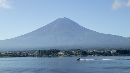 Mount fuji san at Lake kawaguchiko in japan on Day.Fisherman with beautiful sunrise mood of Fuji Mountain at Yamanaka lake.