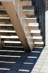 A staircase with a shadow cast on the ground