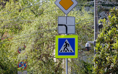 A sign with a person walking on it is on a pole