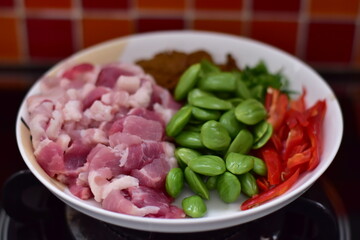 Spicy stir fried pork with Cluster Bean (Bitter Bean or stink beans) popular southern Thai food, Spicy stir fried chicken with Cluster Bean (Bitter Bean or stink beans).Thai southern food