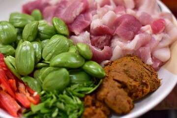 Spicy stir fried pork with Cluster Bean (Bitter Bean or stink beans) popular southern Thai food,...