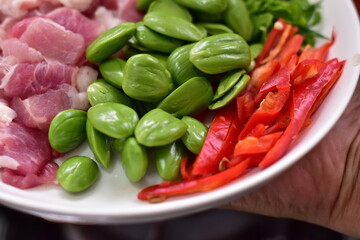 Spicy stir fried pork with Cluster Bean (Bitter Bean or stink beans) popular southern Thai food, Spicy stir fried chicken with Cluster Bean (Bitter Bean or stink beans).Thai southern food