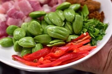 Spicy stir fried pork with Cluster Bean (Bitter Bean or stink beans) popular southern Thai food, Spicy stir fried chicken with Cluster Bean (Bitter Bean or stink beans).Thai southern food