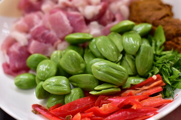 Spicy stir fried pork with Cluster Bean (Bitter Bean or stink beans) popular southern Thai food,...