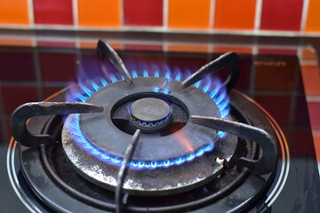 Gas burning from a kitchen gas stove, double black gas burner with blue flame