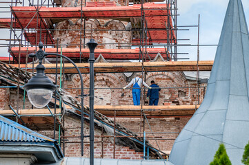 Art restorers are engaged in the restoration and renovation of an ancient, dilapidated church.