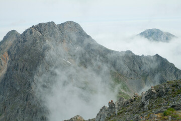 rocky mountain summit shrouded in fog