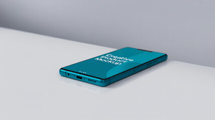 Modern teal smartphone mockup displaying creative product design on a clean white surface