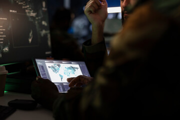 Army officers managing air traffic control using radar surveillance software on tablet. Close up of...