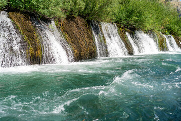 Fototapeta premium Cascading waterfalls in Bunski Kanal near Blagaj, Bosnia and Herzegowina