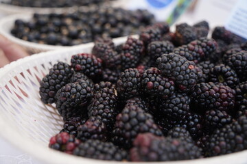 Berries on a large plate on the table. Summer harvest.