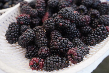 Berries on a large plate on the table. Summer harvest.