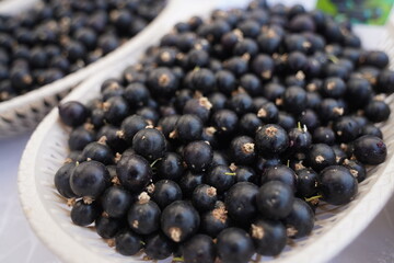 Berries on a large plate on the table. Summer harvest.
