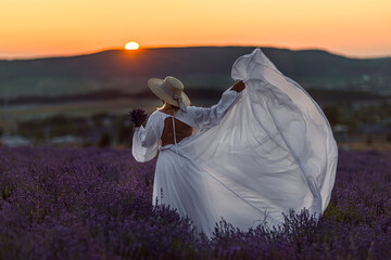 Lavender field dress woman sunset romantic holiday in summer landscape.