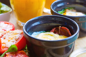 Tomato backed with cheese in a bowl