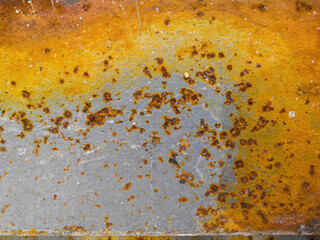 Rusty metal surface. Old paint and corrosion spots are visible. Yellow, brown, red colors of...