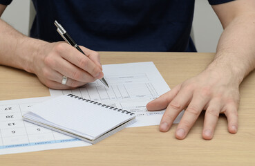 A man makes a complaint about a product, he has a purchase document in front of him