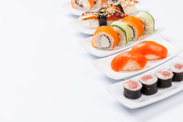 Assorted sushi and maki rolls beautifully arranged on plates