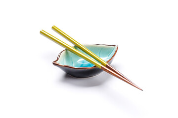 A sushi chopsticks and a small bowls, elegantly arranged on a clean white background