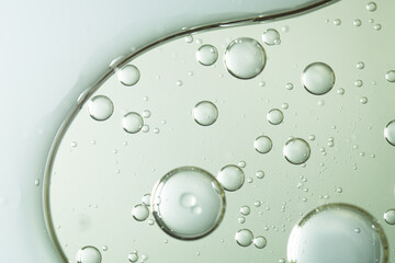 A macro abstract image of oil bubbles suspended in clear liquid, evoking facial serum texture. Ideal for beauty, cosmetic, and skincare-themed visuals.