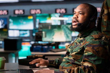 Military officer in command post having shocked look on face after receiving intel on enemy battle...