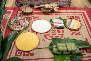 Woman with traditional Tay dress Making (wrapping) Tet Cake, the Vietnamese lunar new year Tet food...