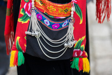 Close up accessories such as jewelry are attached or hung on the traditional costumes of the Tay...
