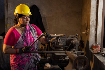 Female maintenance engineer with mechanic measuring using micrometer at workshop