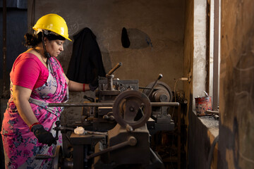 Indian female engineers are operating lathes in the workshop.