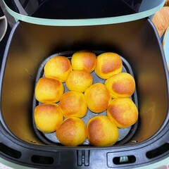 Freshly baked golden - brown pumpkin dough balls in an air fryer look temptingly delicious. Their...