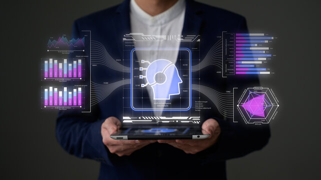 A person in a suit holds a tablet displaying futuristic AI and data analytics visuals, including charts, graphs, and a digital human head icon.