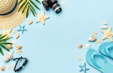 Summer accessories creating frame on light blue background with copy space