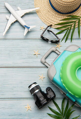 Travel accessories lying on wooden background for summer vacation trip