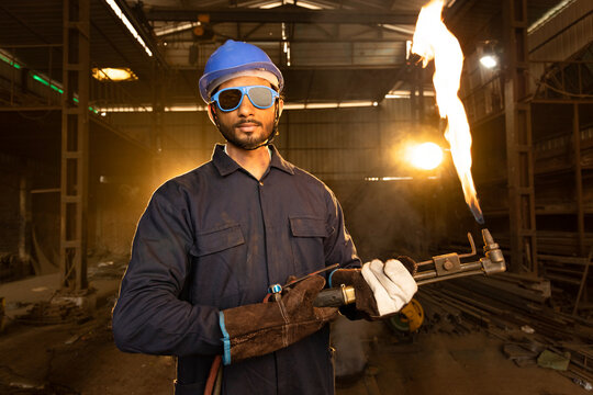 Handyman preparing his autogenous welding tool in workshop.