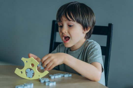 Boy playing with an educational balance game at home