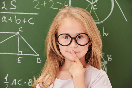 girl in glasses by board