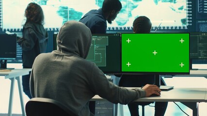 Professional team of governmental hackers conducting cyber surveillance, looks at isolated copy...