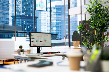 Empty financial department with stock portfolio on computer screen and paperwork files filled with...