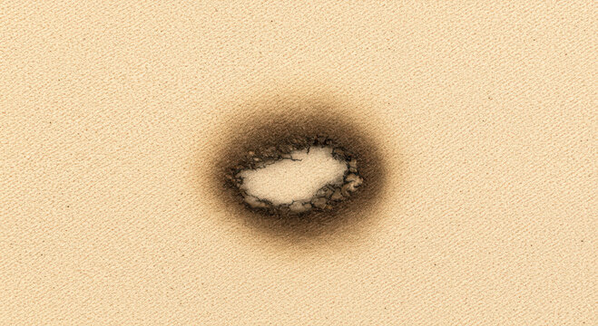 burn mark on canvas creates striking contrast, symbolizing potential hazards and material damage in artistic projects. rugged texture highlights vulnerability and aesthetic complexity