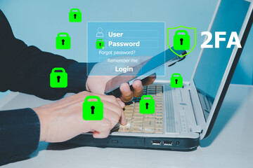 Cybersecurity and two-factor authentication (2FA) concept. A user logging in on a laptop with...