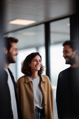 Smiling business team having casual conversation in modern office environment