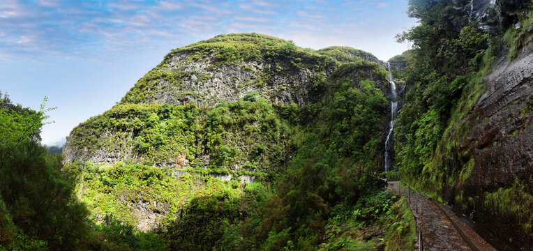 Waterfall Risco with levada in Madeira with green vegetation, Portugal