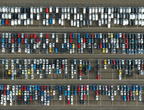 Aerial view of electric and fossil fuel cars and vans in a parking lot at Vlissingen harbor, Netherlands