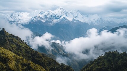 Majestic snow-capped mountains rise above a sea of clouds, nestled amidst lush green valleys and hills