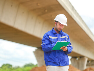 Inspector or engineer is inspecting construction and quality assurance new house using a blue...